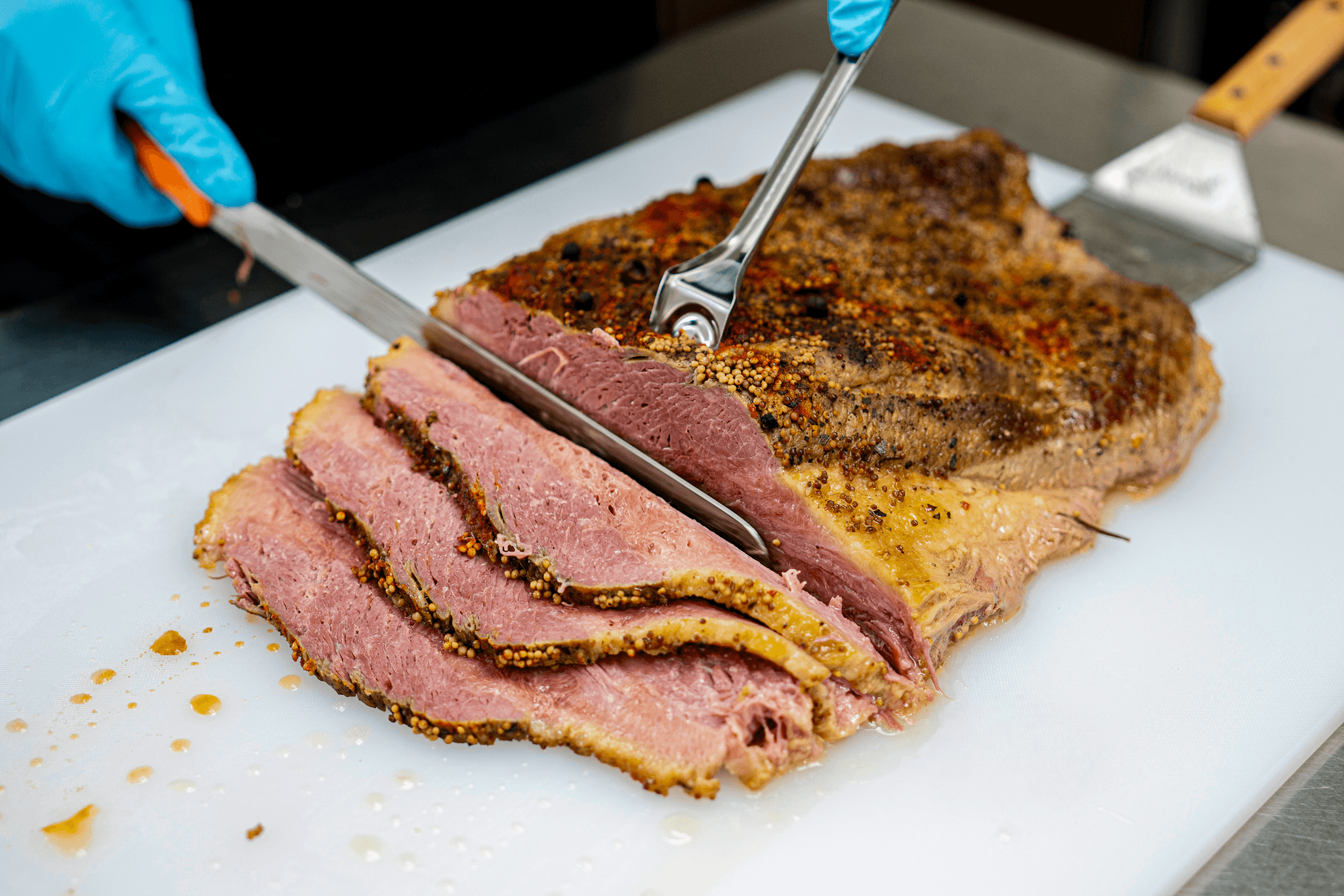 Hand-slicing house-cured corned beef brisket