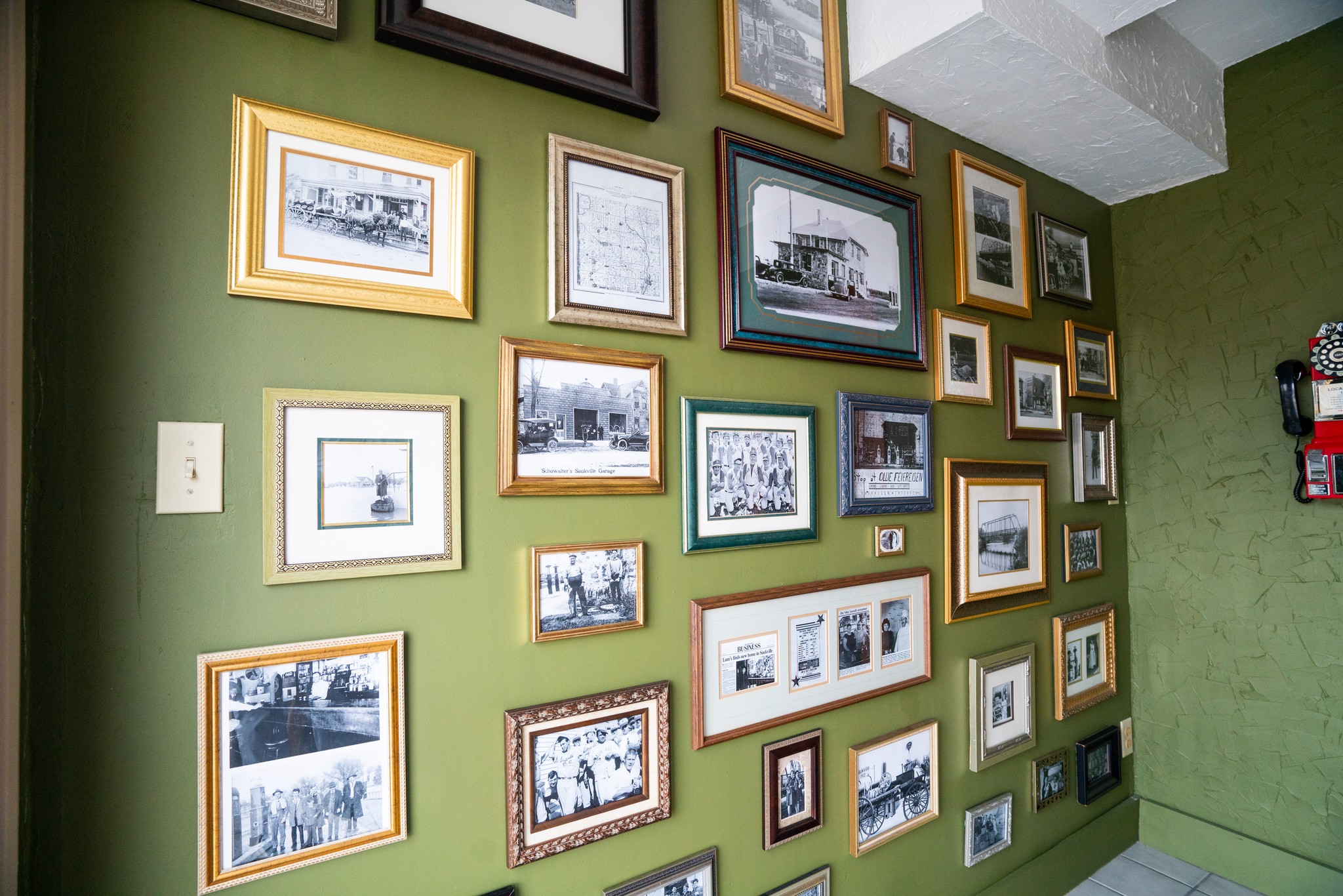 Framed Saukville history photographs lining the Redstone Kitchen wall